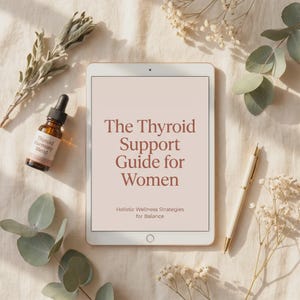 May include: A tablet displaying the text The Thyroid Support Guide for Women Holistic Wellness Strategies for Balance, accompanied by a small amber glass dropper bottle labelled Thyroid Harmony Blend and a gold pen on a neutral fabric surface.