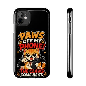 May include: A black smartphone case featuring a graphic of an angry orange tabby cat wearing a black cape and holding a phone. The text reads PAWS OFF MY PHONE! THE CLAWS COME NEXT. The design includes orange and red lettering on a black background.