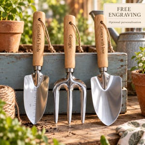 May include: Three gardening tools with light wood handles and silver metal heads. The left trowel features measurement markings of 5 and 10. The handles are engraved with the text Grandad's Tools, Georgie, and Grown with love, each with a jute cord loop.
