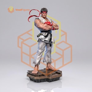 May include: A detailed figurine of a martial artist standing with arms crossed, wearing a white karate gi with a black belt, red gloves, and a red headband. The figure is positioned on a brown wooden plank base, showcasing a muscular build.