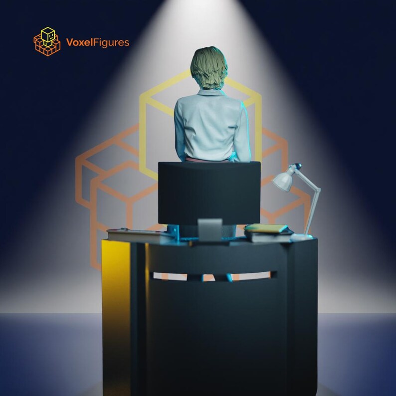 May include: A figurine of a person with short hair wearing a light blue shirt, seated at a black desk with a computer monitor, a small lamp, and books. The text VoxelFigures appears in the top left corner with a yellow cube icon.