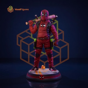 May include: A Deadpool figurine wearing a red hooded jacket, black pants, and sneakers, standing on a circular base. The character holds a baseball bat across the shoulders, features a belt with holsters, and has a small yellow rubber duck at the feet. The text VoxelFigures appears in the upper left corner.