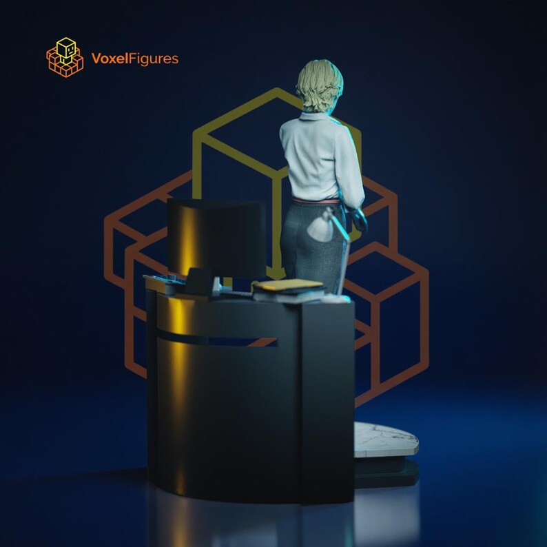May include: A figurine of a person with short blonde hair wearing a white collared shirt and a dark skirt, standing behind a black desk with a computer monitor and a small lamp. The text VoxelFigures appears in the top left corner of the image.