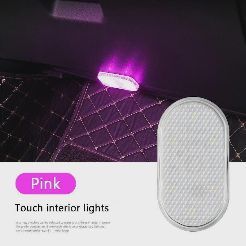 May include: An oval-shaped, white touch interior light for vehicles with a textured surface. The light is shown illuminated with a pink glow in a car interior setting. The text on the image reads Pink Touch interior lights.