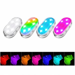 May include: Four oval-shaped LED lights with textured surfaces, each emitting a different color: white, a multi-color gradient, blue, and pink. Below, seven smaller square panels display the lights illuminating a car floor mat in red, purple, orange, pink, blue, cyan, and green.