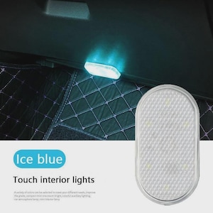 May include: An oval-shaped, white touch-activated interior light for vehicles. The light features a textured, grid-patterned surface and emits an ice blue glow when illuminated. The text on the image reads Ice blue Touch interior lights.
