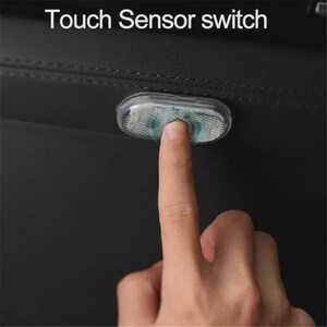May include: A small, oval-shaped, clear plastic touch sensor switch light mounted on a black surface. The device features a textured, translucent cover and is being activated by a finger. The text "Touch Sensor switch" appears above.