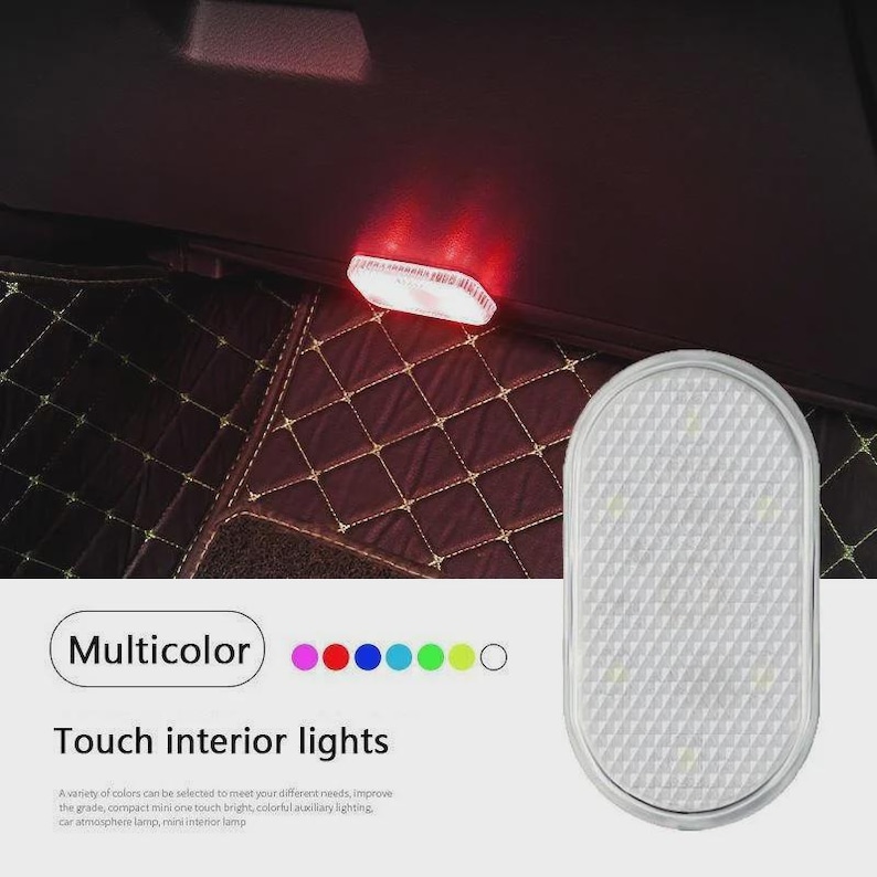 May include: An oval-shaped, white touch-activated interior light with a textured, grid-patterned surface. The device emits a red glow in the upper portion of the image. Text on the image reads "Multicolor" and "Touch interior lights."