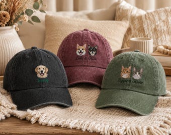 May include: Three baseball caps in charcoal, maroon, and olive green. Each cap features embroidered pet portraits and names: a golden retriever labeled Buddy, a corgi and a black dog labeled Loki & Ollie, and two cats labeled Tigger & Oliver.