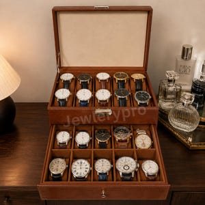 May include: A brown leather watch storage box with a hinged lid and a pull-out drawer, featuring twenty individual compartments. Each slot contains a wristwatch with various dial colors, leather or metal bands, and the text Jewlerypro is visible.