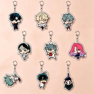 May include: A collection of nine acrylic keychains featuring various chibi-style anime characters with distinct hair colors, facial expressions, and outfits. Each charm is attached to a silver-toned metal split ring and lobster claw clasp.