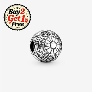 May include: A spherical silver charm bead featuring intricate engraved geometric patterns and a central circular design. The charm has a hollow centre and a metallic finish. A circular badge in the corner displays the text Buy 2 Get 1 Free.