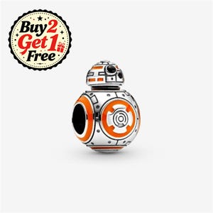 May include: A spherical silver charm featuring the character BB-8 with orange and black enamel detailing. The charm has a rounded head and a circular body with mechanical patterns. A circular badge in the corner displays the text Buy 2 Get 1 Free.