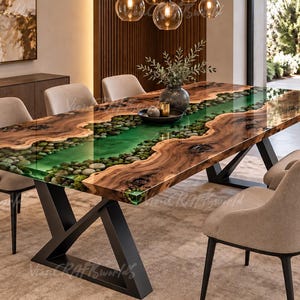 May include: A rectangular dining table featuring a live-edge wood slab with a central river design made of translucent green resin and embedded river stones. The table is supported by a black metal X-shaped base and surrounded by beige chairs.