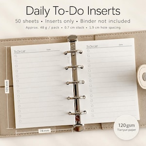 May include: Daily To-Do Inserts with 50 sheets, 120 gsm paper, and 1.9 cm hole spacing. The white paper pages measure 105 mm by 74 mm and feature a To-Do List header with checkboxes and lines. The inserts are held by a silver metal binder mechanism.