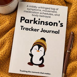 May include: A white tracker journal with black text that reads A mildly unhinged log of symptoms, movement, medication schedules, and body betrayal. Parkinson's Tracker Journal. Tracking the moments that matter. Features a cartoon penguin illustration.