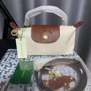 Bolso bandolera mini blanco de Longchamp con correa para el hombro desmontable.