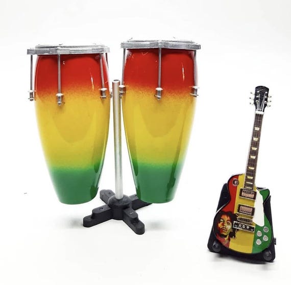 A genuinely handcrafted miniature wooden Bob Marley guitar and reggae conga set with a stand — the kind of tiny desk sculpture you didn't know existed.