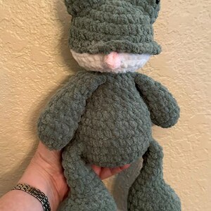 Puede incluir: Un juguete de rana de peluche hecho a mano en tonos verdes, blancos y rosas. La rana tiene ojos grandes y redondos, una barriga blanca y una boca rosa. El material suave y texturizado le da a la rana una apariencia achuchable. Un art&iacute;culo encantador, hecho a mano.