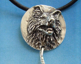 May include: A silver pendant necklace featuring a detailed wolf head with a feather charm. The necklace is on a black leather cord.
