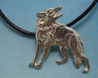 May include: A silver wolf pendant on a black leather cord. The wolf is howling and has a detailed, textured design.