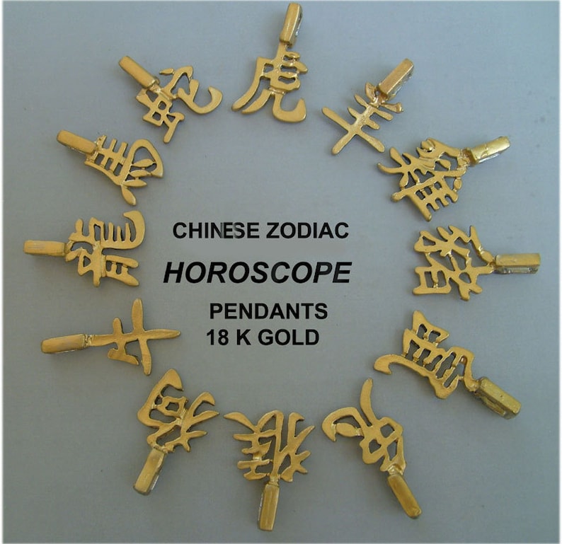 May include: Twelve gold pendants featuring the Chinese zodiac animal symbols. The pendants are arranged in a circle and labeled "CHINESE ZODIAC HOROSCOPE PENDANTS 18 K GOLD".