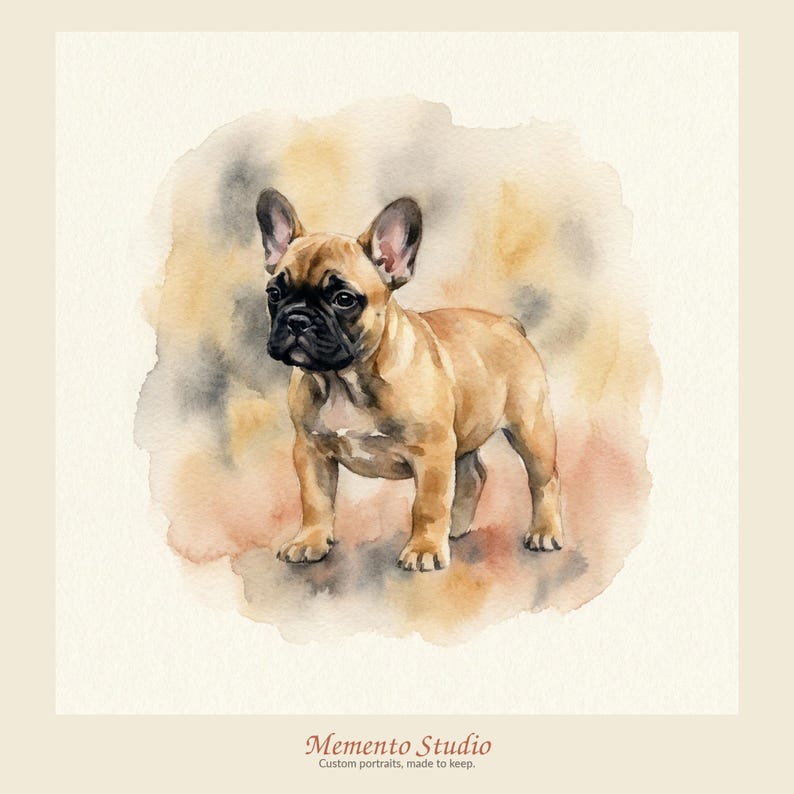 May include: A watercolour painting of a fawn French Bulldog with a black muzzle and large ears, standing in a profile view. The dog is set against a soft, blended wash of tan, brown, and grey watercolour tones. Text at the bottom reads Memento Studio.