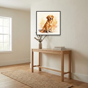 May include: A square framed wall art print featuring a watercolor painting of a golden retriever dog sitting down. The dog has light brown fur and is depicted against a soft, abstract wash of warm yellow and orange tones on a white background.
