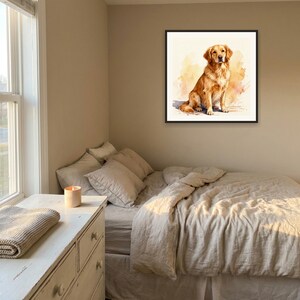 May include: A square framed wall art print featuring a watercolor illustration of a golden retriever dog sitting down. The dog has golden-brown fur and is depicted against a soft, abstract wash of warm yellow and orange tones on a white background.