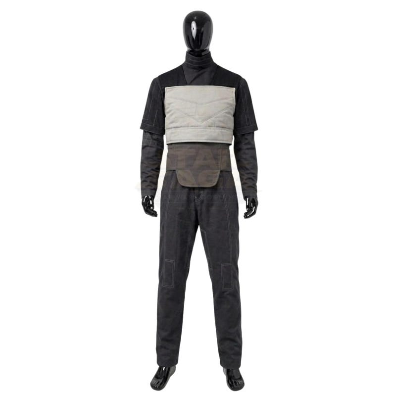 May include: A dark grey long-sleeved shirt and matching trousers set featuring a light grey quilted chest panel and a dark brown waist belt. The ensemble is displayed on a black mannequin, showcasing a structured design with visible stitching details on the trousers and sleeves.