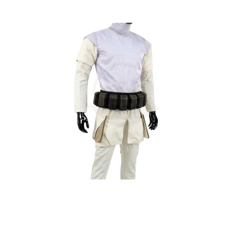 May include: A light-colored short-sleeved shirt with a high collar, paired with matching trousers featuring large side pockets. A black utility belt with multiple rectangular pouches is worn around the waist. The outfit is displayed on a mannequin.