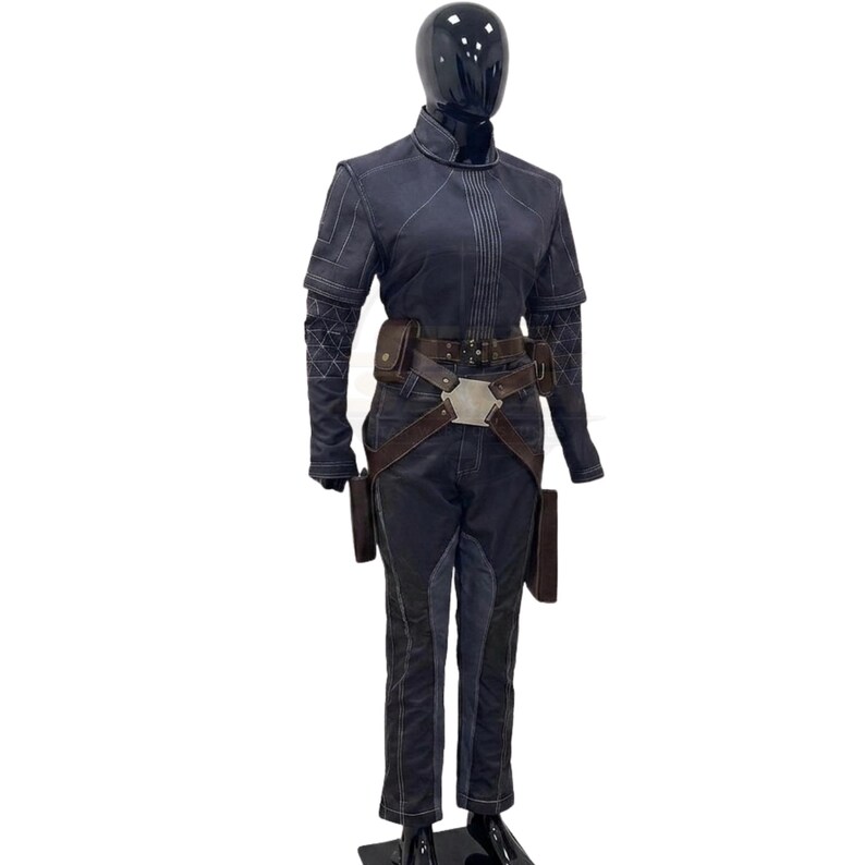 May include: A dark charcoal gray tactical jumpsuit featuring a high collar, short sleeves with geometric patterned under-sleeves, and a brown leather utility belt with a central metallic hexagonal buckle and attached pouches, worn on a black mannequin.