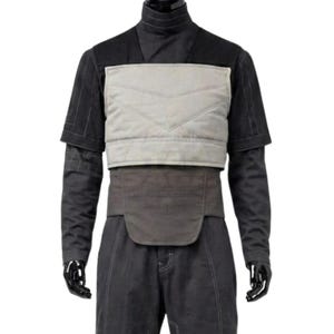 May include: A black long-sleeved shirt and trousers set featuring a light grey quilted chest panel with horizontal stitching. The garment includes a dark grey waist belt with a rounded front flap and visible seam detailing throughout the fabric.