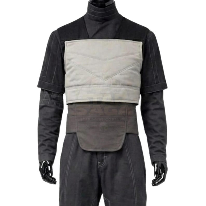May include: A black long-sleeved shirt and trousers set featuring a light grey quilted chest panel with horizontal stitching. The garment includes a dark grey waist belt with a rounded front flap and visible seam detailing throughout the fabric.