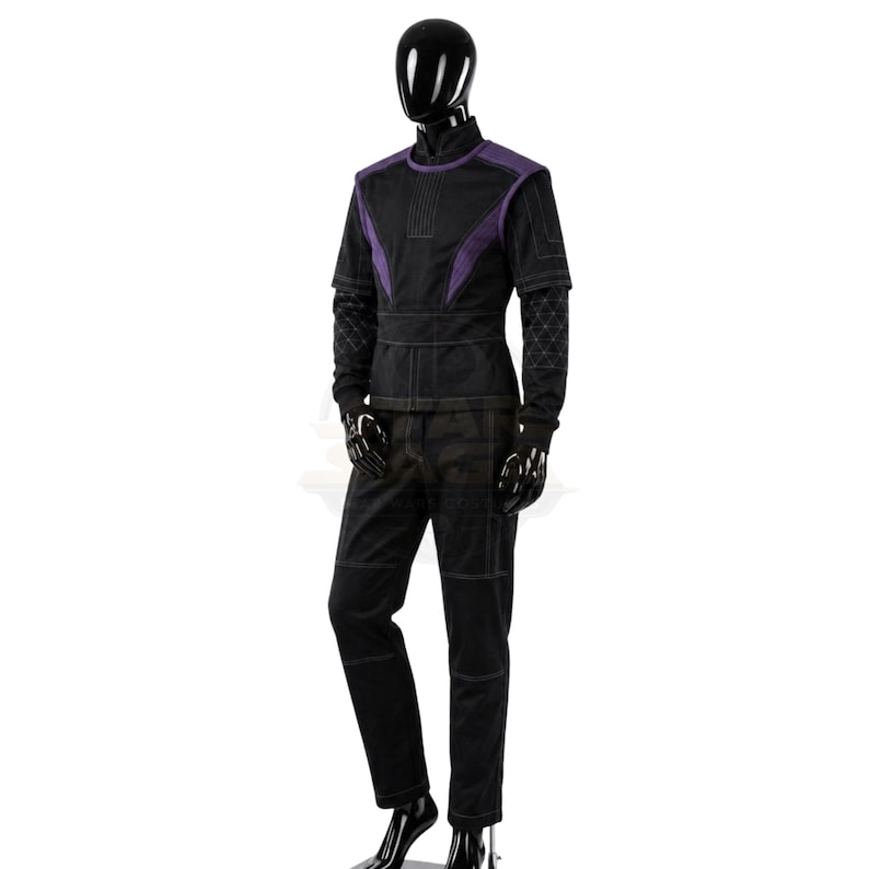 May include: A black and purple tactical-style outfit on a mannequin, featuring a short-sleeved top with purple accents, a high collar, and long sleeves with a geometric grid pattern. The matching black trousers have visible white stitching.