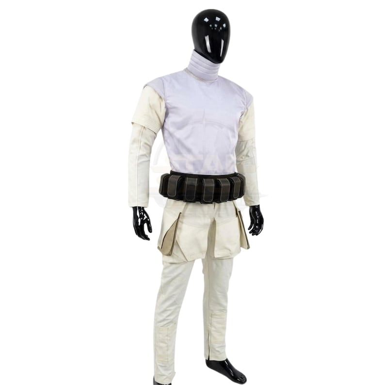 May include: A costume set featuring a light lavender high-neck top with short sleeves, paired with off-white trousers that have large side pockets. A black utility belt with multiple rectangular pouches is worn around the waist over the top.