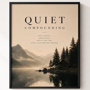 May include: A framed wall art print featuring a landscape of mountains and a lake with pine trees. The text reads: QUIET COMPOUNDING, SMALL CHOICES, CONSISTENTLY, OVER A LONG TIME, CREATE EXTRAORDINARY FREEDOM. The colour palette is beige, black, and dark green.