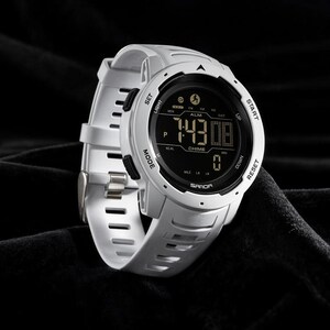 May include: A white digital sports watch with a round face and a black display screen. The watch features a white silicone strap with rectangular cutouts, black side buttons labeled SET, LIGHT, MODE, START, UP, DOWN, and RESET, and the brand name SANDA.