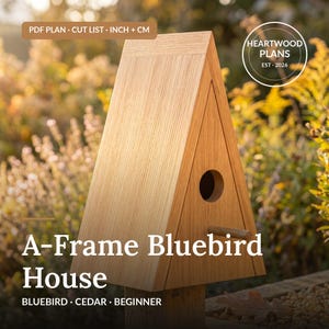 May include: A light brown wooden A-frame birdhouse with a triangular shape, a circular entrance hole, and a small perch. Text on the image reads: PDF PLAN - CUT LIST - INCH + CM, HEARTWOOD PLANS EST 2026, and A-Frame Bluebird House BLUEBIRD - CEDAR - BEGINNER.
