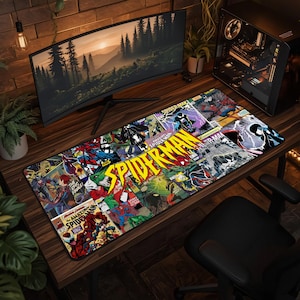 May include: A rectangular desk mat featuring a vibrant collage of vintage Spider-Man comic book covers. The design includes various action scenes with the character in red and blue, alongside the bold yellow text Spider-Man in the center.