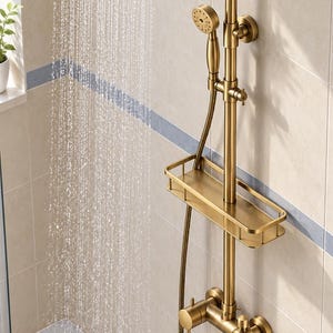 May include: A brushed gold shower system featuring a large round rainfall showerhead, a handheld shower wand with a flexible hose, a rectangular storage shelf, and a wall-mounted faucet with a spout, all actively dispensing water.