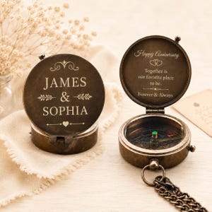 May include: A round, antique-style brass compass with a hinged lid. The lid is engraved with the names JAMES & SOPHIA. The interior lid features the text Happy Anniversary, Together is our favourite place to be, and Forever & Always.