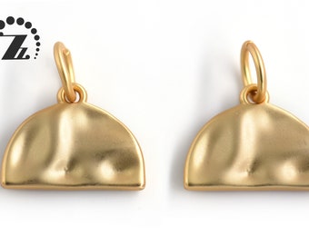 May include: Two gold-toned metal half-circle pendant charms with a smooth, textured surface. Each charm has a small loop at the top for attaching to a necklace or bracelet.