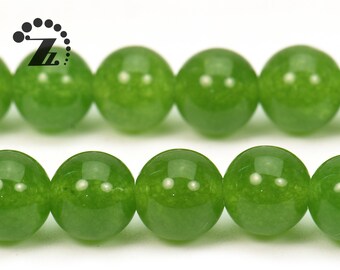 Op de afbeelding: Een streng ronde, groene jade kralen. De kralen zijn glad en gepolijst, met een lichte glans.