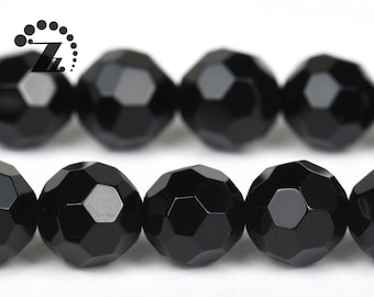 May include: A strand of black faceted gemstone beads. The beads are round and have a shiny finish.
