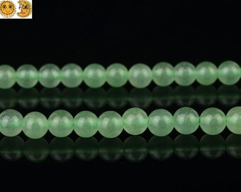 May include: A strand of light green jade beads. The beads are round and smooth, and they are strung on a clear thread.