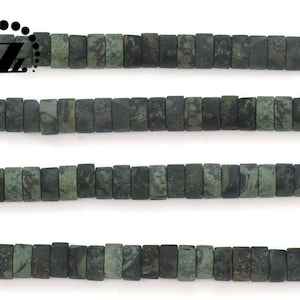 May include: Strands of rectangular, dark green beads with a mottled pattern. The beads are strung together, creating a linear arrangement. The beads are approximately 0.25 inches in length. The beads are likely for jewelry making.
