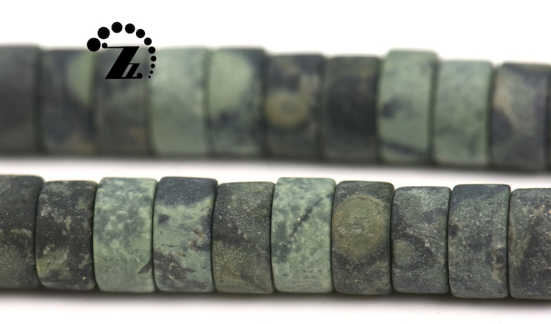 May include: Two strands of dark green, rectangular beads with a mottled pattern. The beads have a slightly rough texture and are strung together, suitable for jewelry making or crafts.