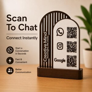 May include: A dark brown and white arched sign featuring the text Scan To Chat, Connect Instantly, and Creative Mind You imagine. We create. The sign includes three QR codes with icons for WhatsApp, Instagram, and Google on a white background.