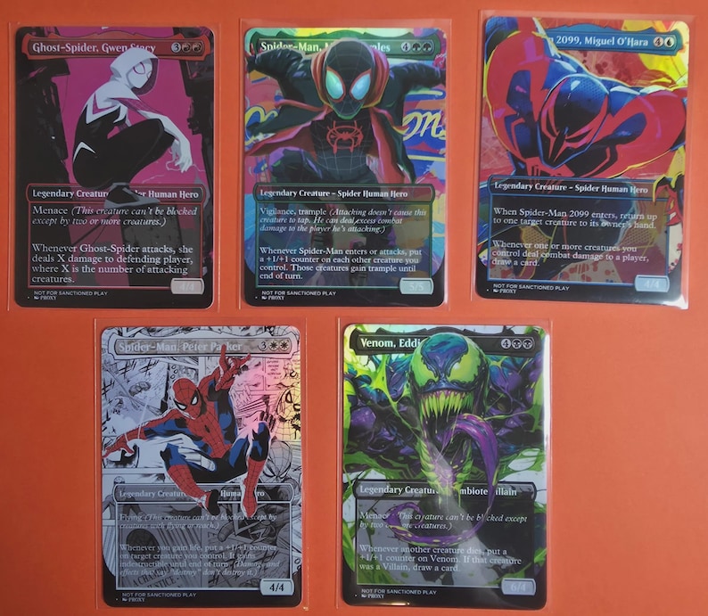 May include: Five rectangular trading cards featuring comic book characters including Ghost-Spider, Spider-Man Miles Morales, Spider-Man 2099, Peter Parker, and Venom. Each card displays colorful character illustrations, game text, and power stats.